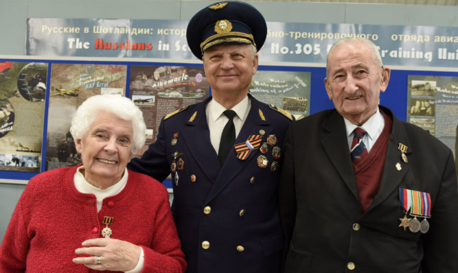 Mrs Ness Vann and Mr David Oswald, right, were presented with Russian 70th anniversary medals by Soviet pilot Alexei Timofeev.