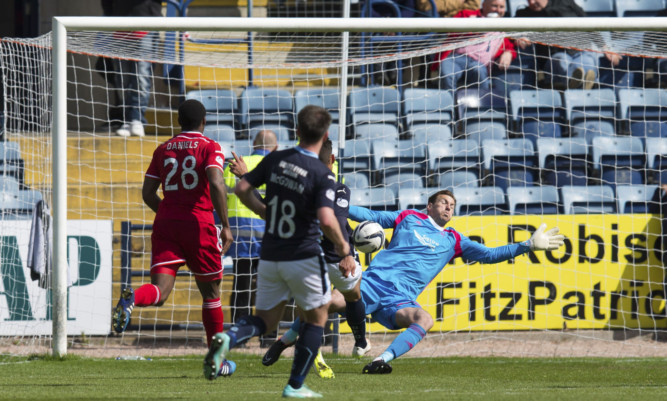 Dundee's Luka Tankulic  slots the ball home to put his side 1-0 up.
