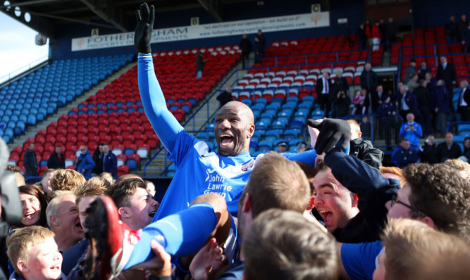 Marvin Andrews hoisted high by fans after the final whistle.