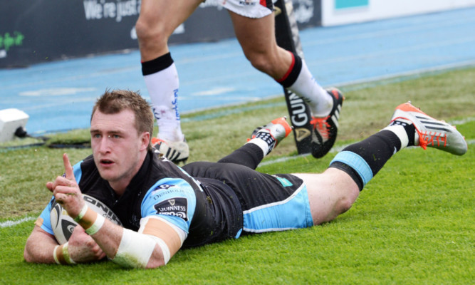 Stuart Hogg celebrates the solo try that turned the tide for Glasgow.