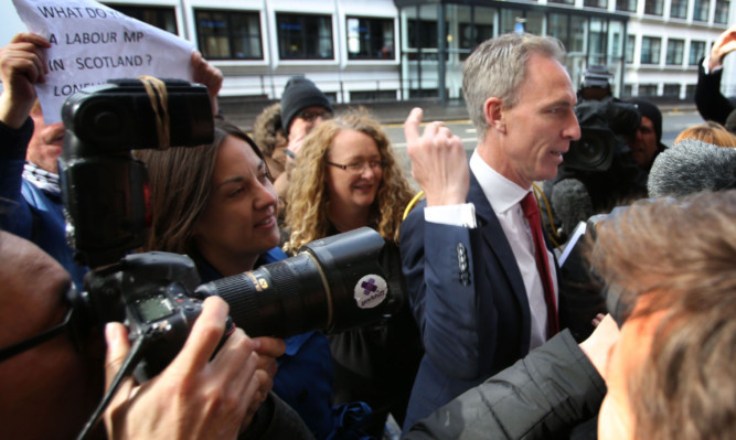 Jim Murphy arrives at the Labour Party headquarters in Glasgow on Saturday before announcing his intention to resign.