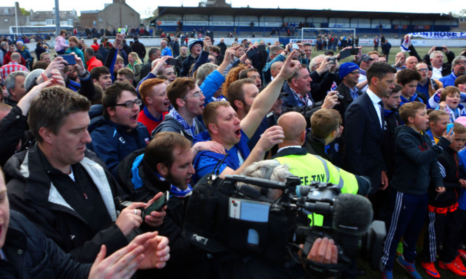 Kris Miller, Courier, 16/05/15. Montrose V Brora, fans celebrate with players on the pitch at full time.