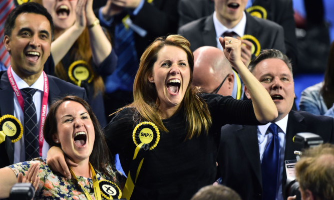 SNP supporters celebrating on what was a disastrous election night for Scottish Labour.