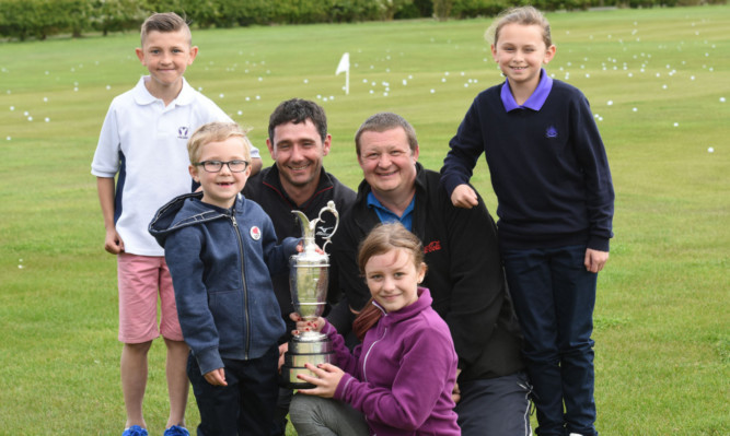 Getting to see the Claret Jug up close at Wellsgreen are, back from left, Jordan Tosh from Kirkcaldy, golf pro Peter Whiteford, Neill Melville from Dunfermline and Beth Farmer from Leven. Front: Alex Dickson from Kirkcaldy and Amy Melville from Dunfermline.