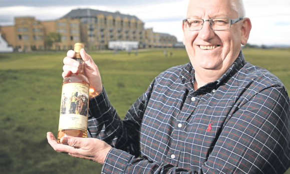 Lennox Harrower with one of the three special edition whiskies.