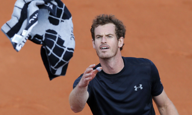 Andy Murray throws his towel to spectators after beating Argentina's Facundo Arguello in three sets.