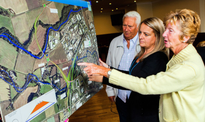 Project manager Sarah Millar looks at the plans with Joe Wyse and his wife Catherine.