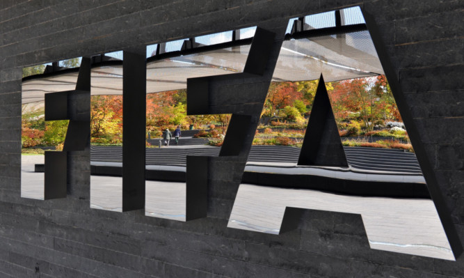 FILE - MAY 27, 2015: According to reports, the U.S. Justice Department plans to announce corruption charges against officials at FIFA, the world's governing body of football. ZURICH, SWITZERLAND - OCTOBER 20:  The FIFA logo is seen outside the FIFA headquarters prior to the FIFA Executive Committee Meeting on October 20, 2011 in Zurich, Switzerland. During their third meeting of the year, held over two days, the FIFA Executive Committee will approve the match schedules for the FIFA Confederations Cup Brazil 2013 and the 2014 FIFA World Cup Brazil.  (Photo by Harold Cunningham/Getty Images)