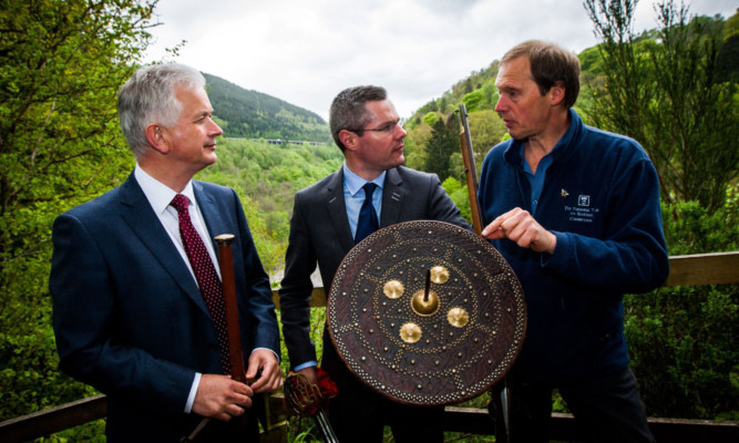 Transport Minister Derek Mackay, centre, gets a crash course on Jacobite weaponry from Iain Reid, left, and Ben Notely of the National Trust for Scotland.
