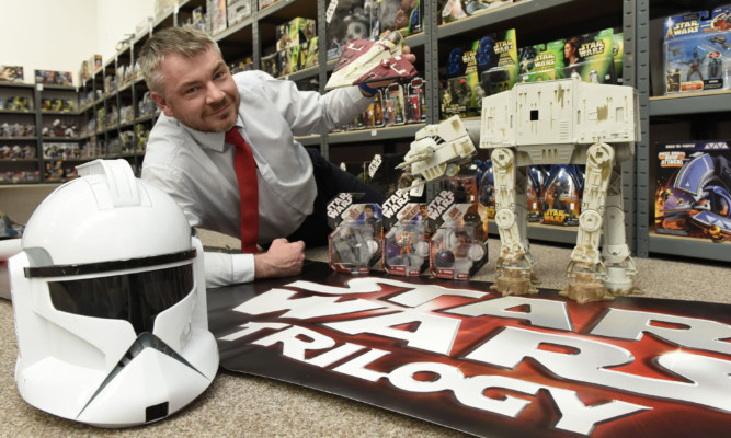 Scott Henderson from Taylors Auction Rooms with some of the Star Wars collection up for sale.