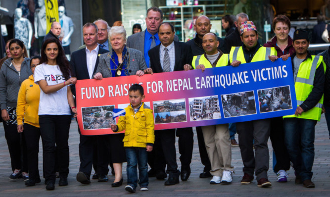 Bhola Khana (centre) with other memebers of the Nepalese community in Perth who gathered for a one minute silence for the victims of the earthquake in Nepal.