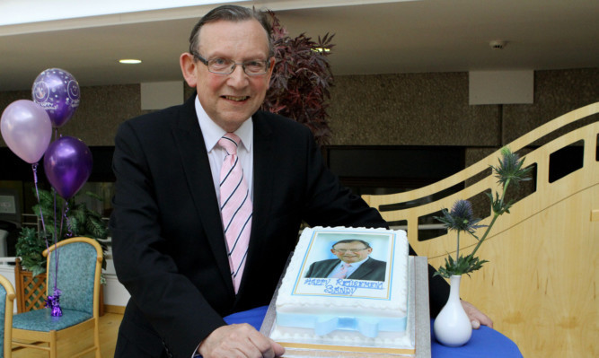 Sandy Watson and his wife, Jean, with a cake to mark his retirement as chairman of NHS Tayside.