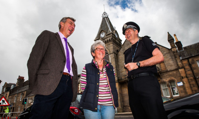 Chief Inspector Ian Scott with Councillor Mike Williamson and Alison Walker, from nearby Trinity Gask, outside Aytoun Hall, Auchterarder.