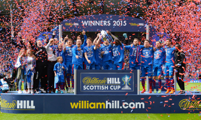 The Inverness players celebrate.