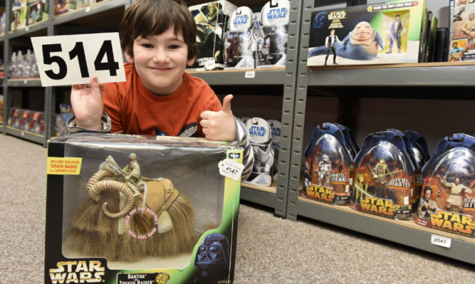 Eight-year-old William Davies was delighted after putting in the winning bid in for lot 4547  a Bantha with a Tusken Raider.