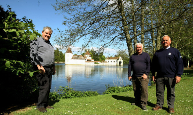 Chairman of the Friends Of Craigton Park Kyffin Roberts (centre),  with vice chairman Doug Stephen (left), and board member Tom Donaldson by the Dutch Village.