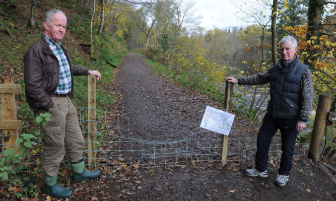 Community councillor Ian Richards and community council chairman David Bailey at the closed-off path.