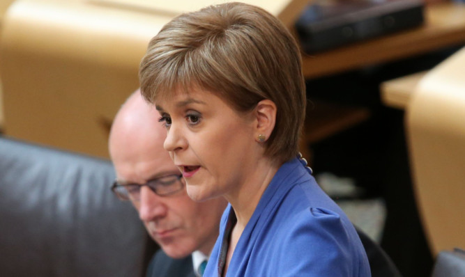 Scotland's First Minister Nicola Sturgeon and Deputy First Minister John Swinney in the debating chamber for FMQ's.