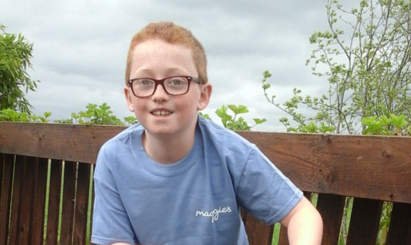Quinn aims to cycle 65 miles with his dad for Maggies.