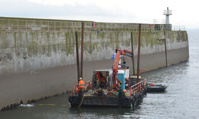 Work is carried out at Pittenweem Harbour to repair the storm damage.