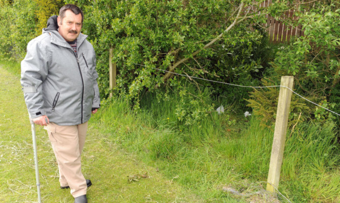 Peter Scobie stands by an area that was used as a toilet by the Travellers.