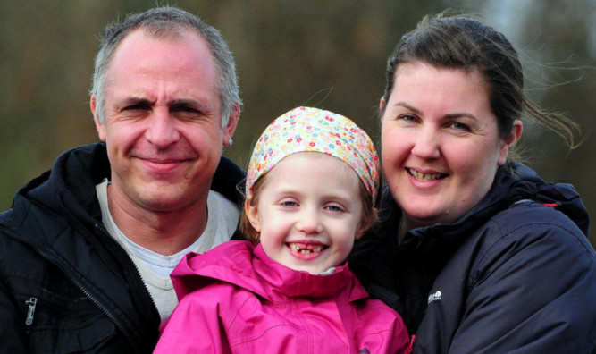 Sophie Gray pictured with her dad Mark and mum Sarah last year.