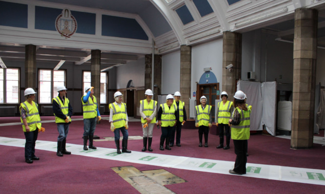 Some of the volunteers visit the site of the new library, museum and gallery.