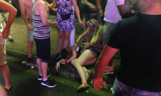 Tourists on the Punta Ballena strip in Magaluf after a night out in the town.