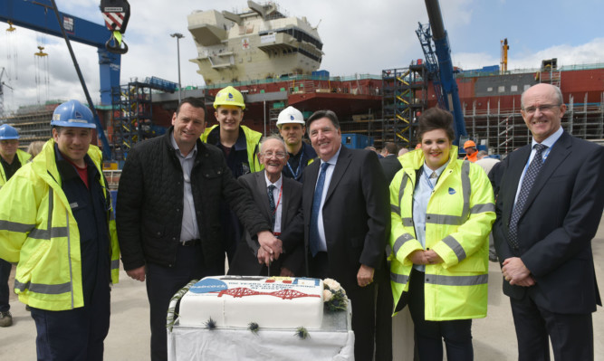 Mr Anderson cuts the cake with, from left, apprentice Chris Marchetti, trade union chairman Raymond Duguid, apprentice Calum Reid,  engineering graduate Mark Casey, Babcock Divisional CEOArchie Bethel, engineering graduate Donna Mapleson and Babcock MD Energy and Marine Services Ian Donnelly.