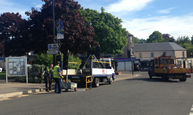 Temporary pedestrian crossings being put in place ahead of this morning's traffic light switch-off in Blairgowrie town centre.