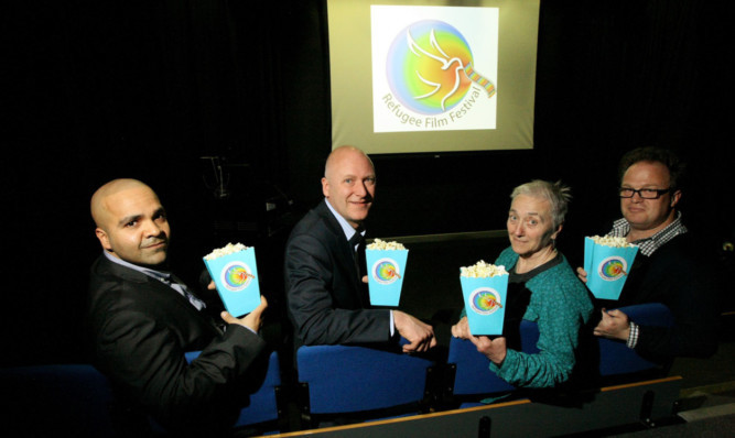 At the launch of the Refugee Film Festival are, from left, Monish Bhatia, Joe FitzPatrick MSP, Florence Germain (Violence Against Women officer) and Wallace McNeish, head of sociology at Abertay.