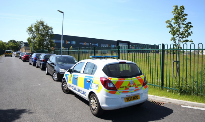 A 14-year-old boy is being hunted by police after a teacher was stabbed at  Dixons Kings Academy in Bradford.