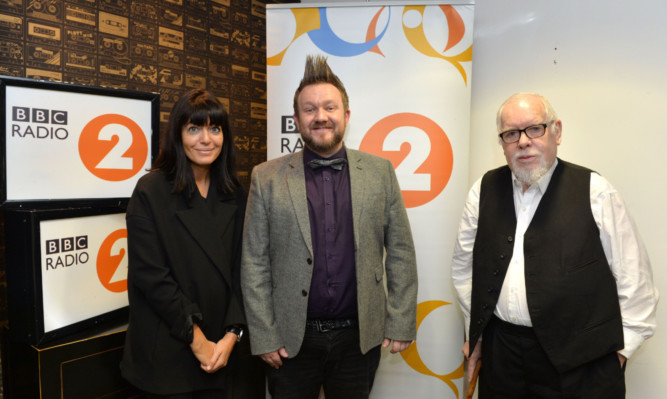 Thomas Small (centre), applicant for BBC Radio 2 Artist in Residence (competition  open to professional artists to win a golden pass to Radio 2 events for 12 months in return for a minimum of four artistic creations) with judges Claudia Winkleman and Sir Peter Blake at Radio 2 in London on 5 June 2015.
Photo by Mark Allan/BBC