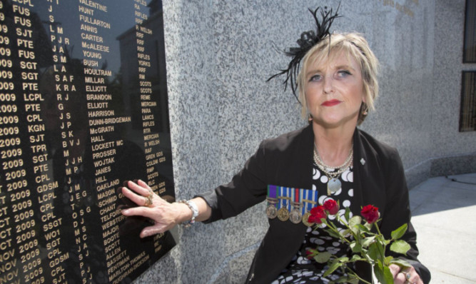 Very emotional: Tam Masons mother, Linda Mason-Buchanan, at the memorial wall.