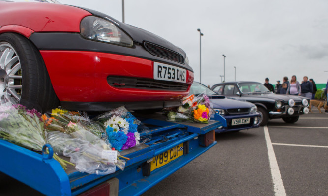 Flowers were laid on the car Brian Phimister was working on before his death.