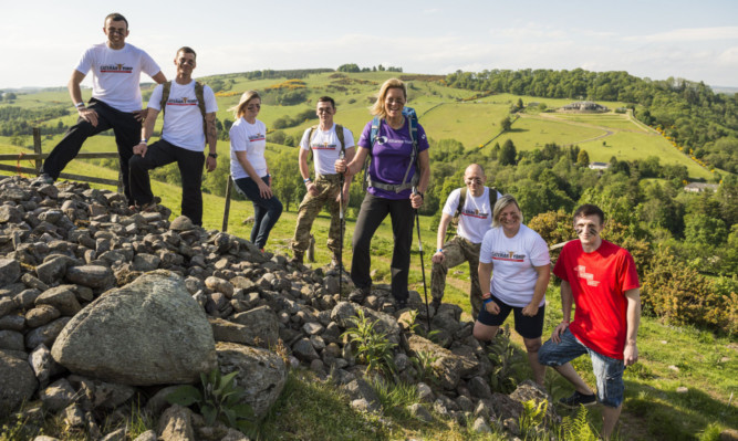 Yomp Ambassador and Scottish adventurer Polly Murray (centre) poses with competitors on a hill above the Cateran Trail.
