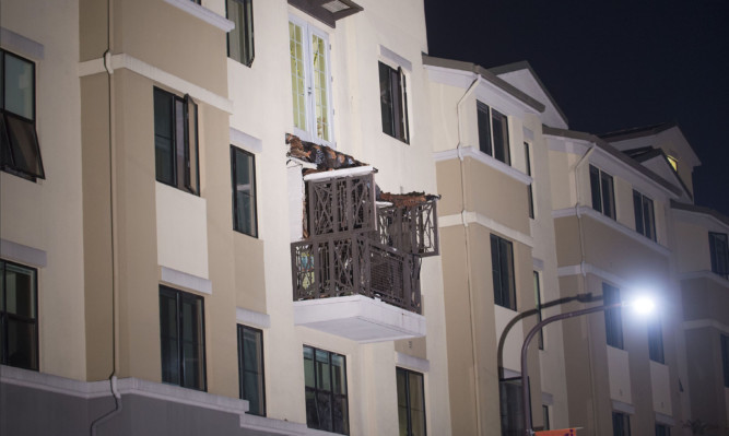 A fourth floor balcony rests on the balcony below after collapsing at the Library Gardens apartment complex in Berkeley, California.