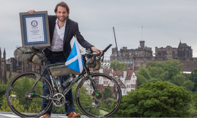 Cyclist and adventurer Mark Beaumont receives his Guinness World Record certificate after shaving 17 days off the Cairo to Cape Town "Africa Solo" cycling challenge record.
