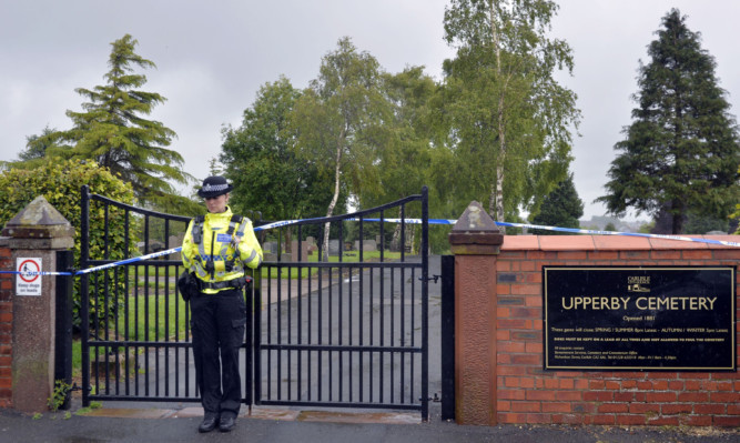 Police outside Upperby Cemetery in Carlisle after the body of 14-year-old Jordan Watson was found following a "savage and brutal attack".