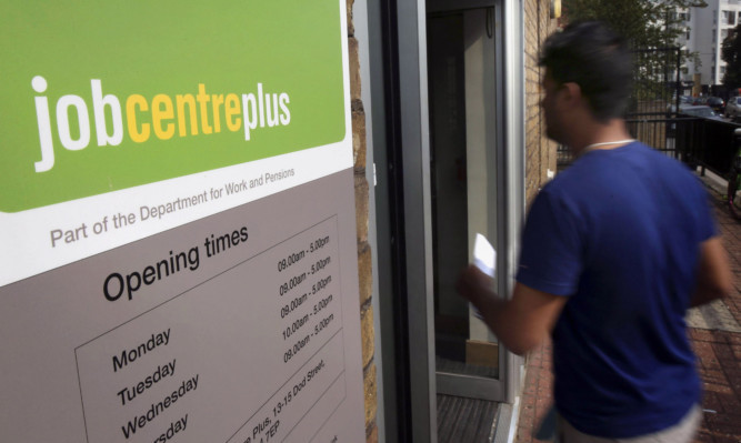 File photo dated 16/09/14 of the entrance to a Jobcentre Plus near Westferry in East London, as the Prime Minister vowed to end youth unemployment in the next Parliament as the Tories set out details of the welfare squeeze that will pay for their plan to create millions of new apprenticeships. PRESS ASSOCIATION Photo. Issue date: Monday October 20, 2014. An extra 40,000 households will be hit as the benefits cap is reduced from £26,000 to £23,000 under the policy, saving £135 million a year. See PA story POLITICS Benefits. Photo credit should read: Philip Toscano/PA Wire