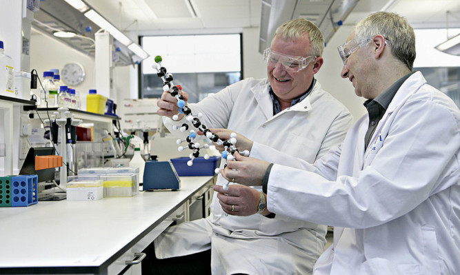 Dr Kevin Read, left, and Professor Ian Gilbert, lead researchers on the project, which has seen its findings published in Nature, with a model of the compound.