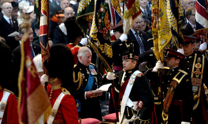 The Prince of Wales watches the Standards, Guidons and Colours of The Battle Of Waterloo arrive in procession at a memorial service for the 200th anniversary of the Battle of Waterloo at St Paul's Cathedral in London.