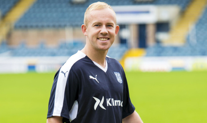 Nicky Low wearing Dundee's new home kit.