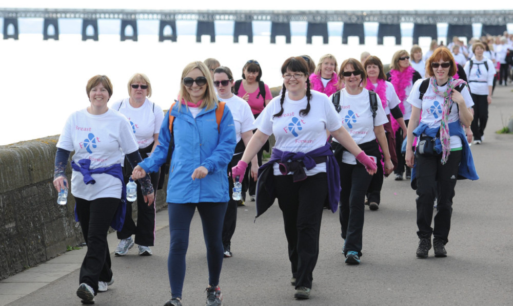 Some of the participants in the Twilight Walk make their way along Riverside Drive.