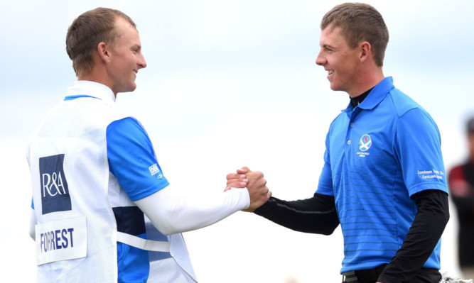 Grant Forrest and caddie Linus Vaisanen celebrate victory in the Amateur semi-finals at Carnoustie.