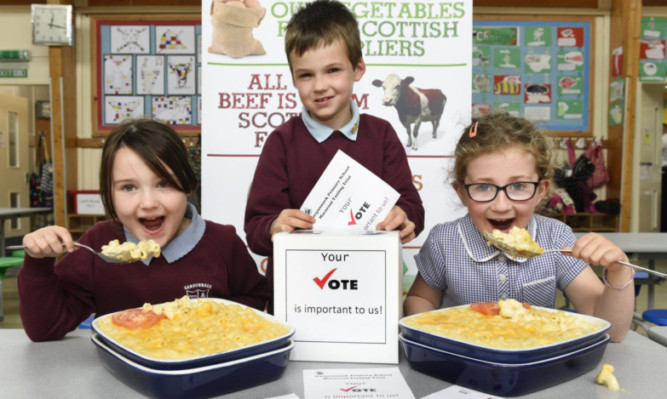 Cheesy grins: sampling some macaroni are, from left, Elise Smith, Angus Park and Ruby Conroy.