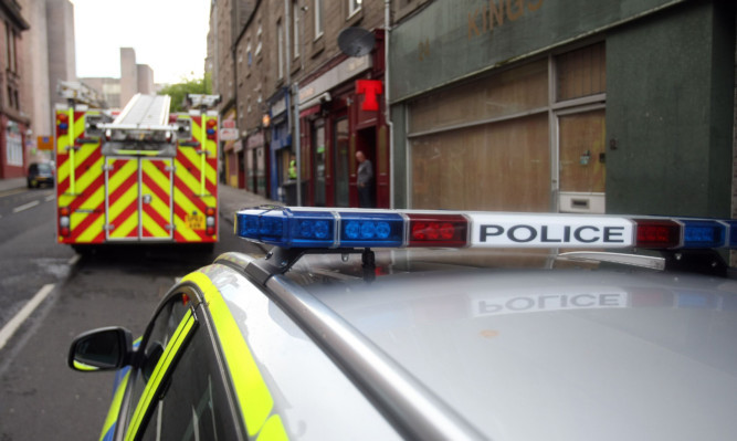 Kris Miller, Courier, 18/05/15. Picture today on St Andrew's Street, Dundee where police and fire brigade were in attendance after a fire. Locals claimed the fire was started due to suspicious wiring. Pic shows police and fire units at the scene.