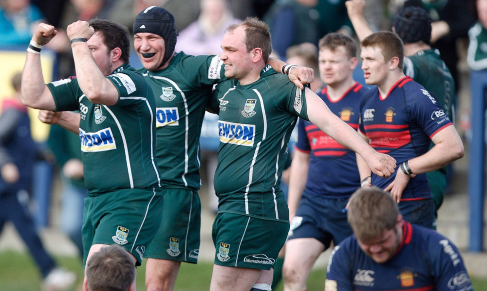 Hawick celebrate at the final whistle as High team members look dejected.