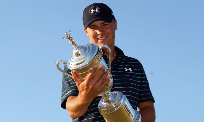 Jordan Spieth contemplates the names on the US Open Trophy.