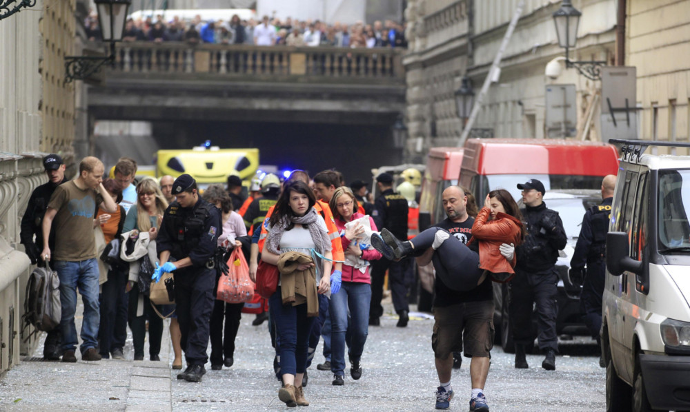 Injured people leave the scene of an explosion in the centre of Prague.